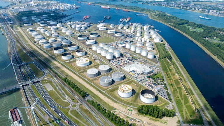 Aerial view of a large industrial tank farm at Port of Rotterdam featuring oil storage tanks