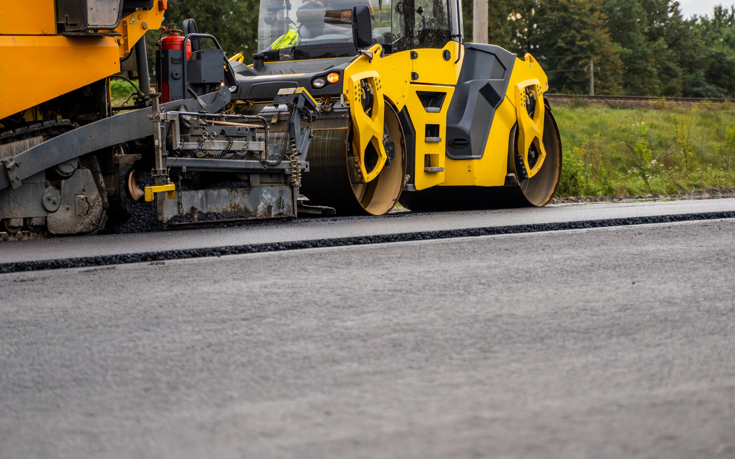 Heavy construction machinery paving asphalt
